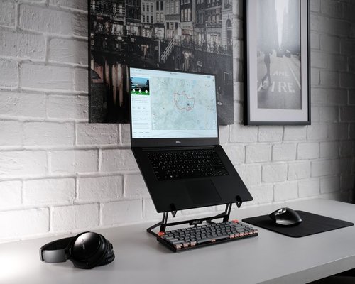 Close up layout of an ergonomic office desk detailing laptop positioning and hydration setup