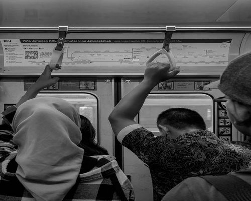 Commuters on KRL train in Jakarta relaxing without constantly looking at electronic devices