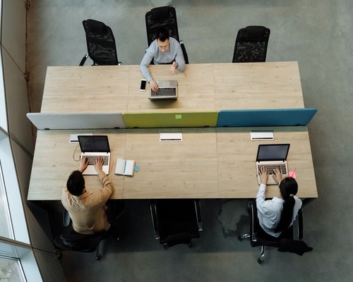 A shared layout of hot desks inside a creative community hub facility
